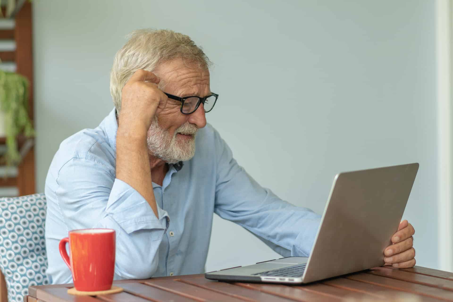 Portrait senior man using laptop